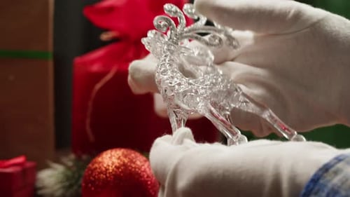 Hands Display a Crystal Christmas Reindeer Ornament