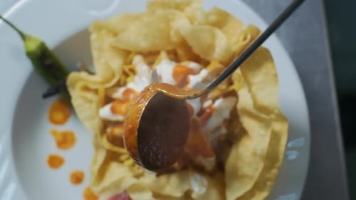 The chef pours tomato sauce on the food in slow motion. Cooking in restaurant, Chef serves cooked ch