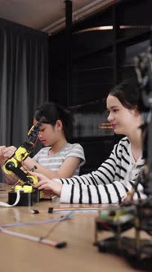 Child and Young Adult Work on Robotics Project