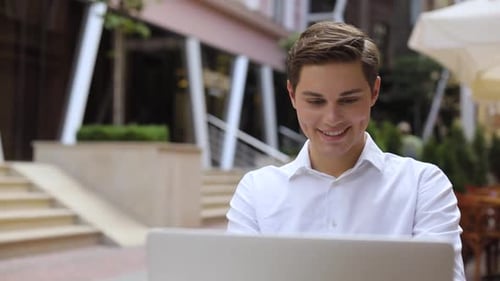 Smile Attractive Man Use of Laptop Computer at Outdoor Near Business Center Happy Screen Work