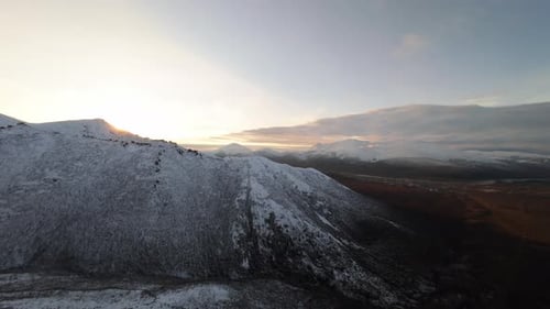 Snowy Mountain Range at Sunrise Aerial View