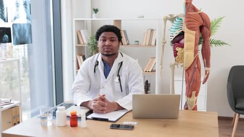 Friendly Doctor in Office Smiling At Camera