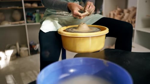 Close Up in Clay Modeling Studio Young Girl Hands Giving Shape to Clay on a Potter's Wheel Applied