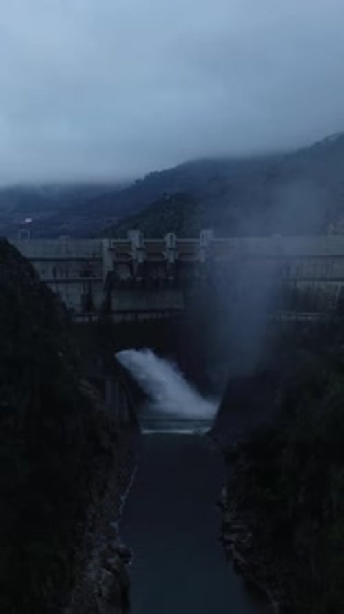 Vertical Video of Water dam in the mountains view from above