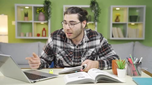 Young Adult Studies at Desk in Home