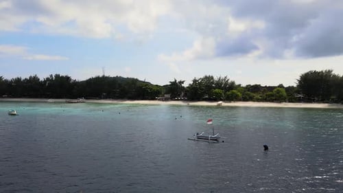 Boats At The Blue Water Of The Beach At Daytime In Bali, Indonesia. aerial