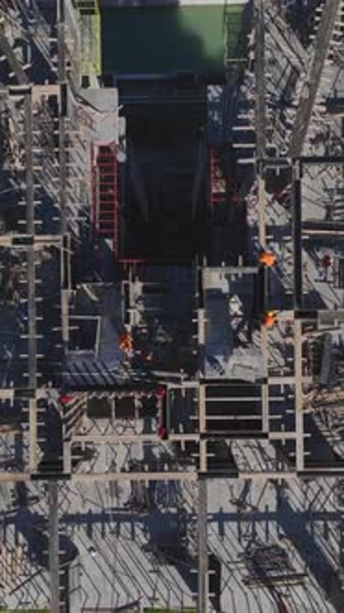 Vertical Video of a Residential Site With Workers Pouring Concrete and Engineers Reviewing Plans