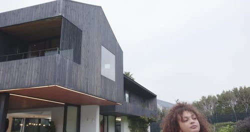 Young Woman Smiling in Luxury Home Backyard