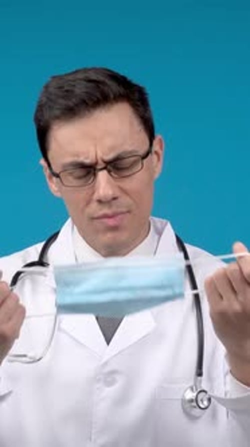 Serious Doctor with Medical Mask in Studio