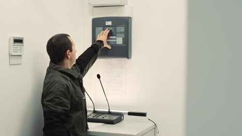 Man Using Modern Control Panel in Workplace