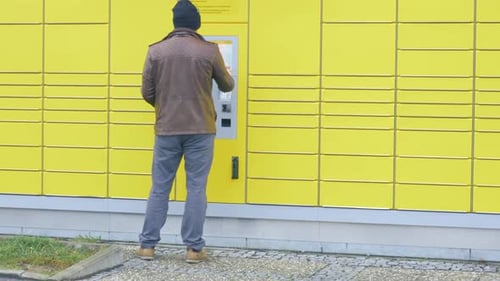Man Retrieving Package from Automated Delivery Locker
