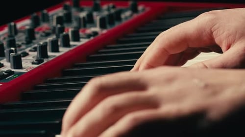 Close Up of Keyboard Player Hands Playing Rock Music with Keyboard at the Concert in Studio
