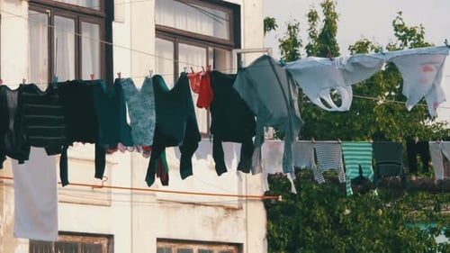 Clothes Weigh Dry on Rope in MultiStorey Building in Poor Neighborhood of City