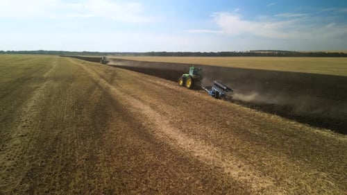 Tractors plowing the field in Ukraine