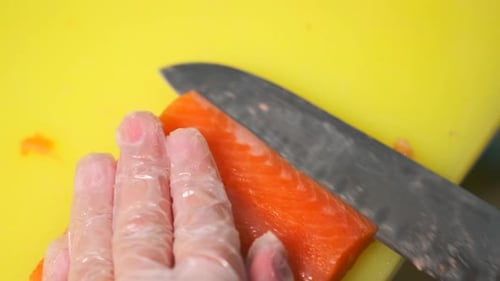 Fresh Salmon Fillet Being Cut by Chef
