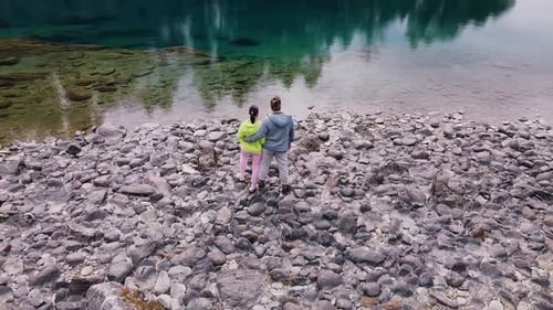 A Couple Enjoys the Serene Lakeside View Embraced By Natures Beauty and Tranquility