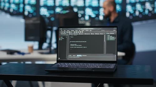 Close Up Shot of Code Lines on Notebook Display in Data Storage Facility