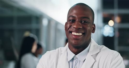 Man, face and doctor with smile for healthcare services, surgery or help in busy hospital at night