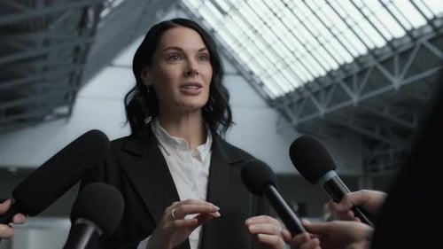 Serious bank executive answers journalists questions at corporate press conference