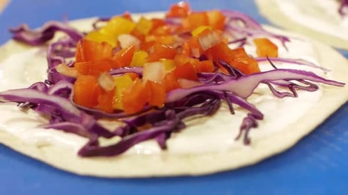Preparing Colorful Vegetable Topped Tortilla Wrap