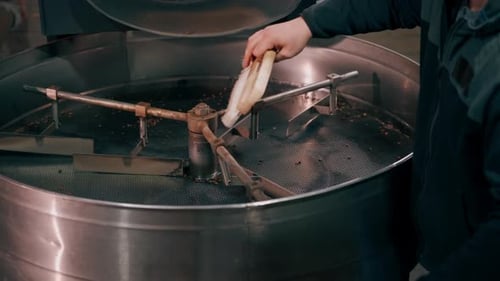 Closeup of a Coffee Roasting Factory Empty Idle Machine Drum with Coffee Residues