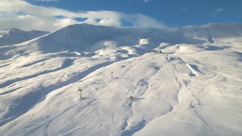 winter landscape of a serene snow-covered ski resort in the mountains, showcasing snowy slopes and