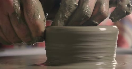 Hands Shaping Clay on Pottery Wheel Close Up