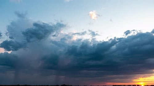 Dramatic Storm Clouds at Sunset Moving Across Sky