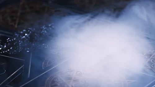 Metal Pendant on Tarot Cards with Smoke