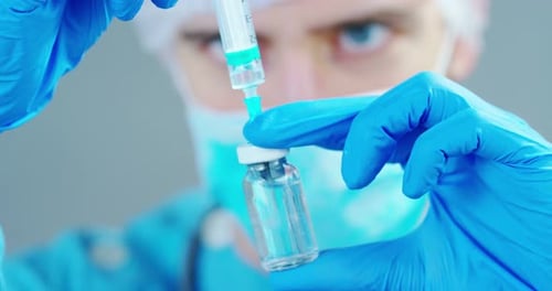 A doctor or scientist in laboratory holding a syringe with liquid vaccines for children or older a