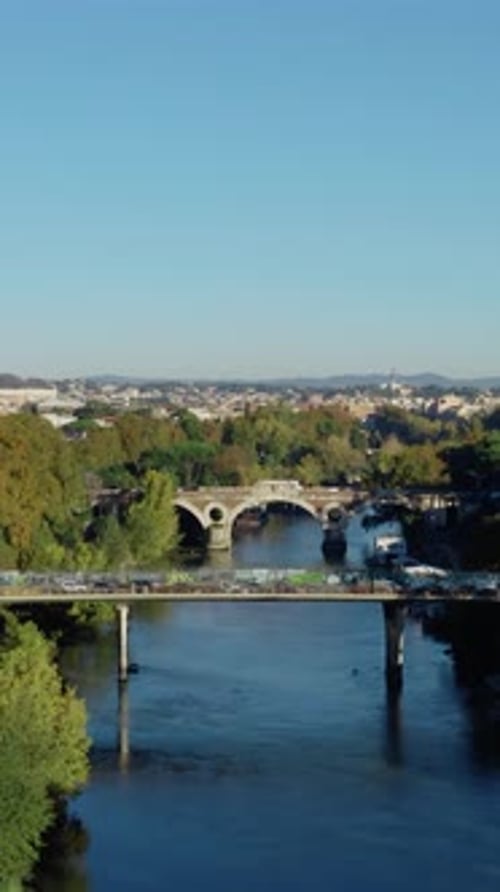 Vertical Drone View of Rome Historic Center with Tiber River Bridge, Urban Traffic, Autumn Trees