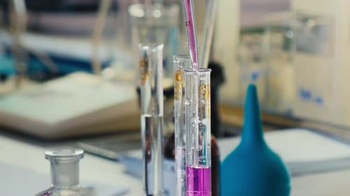 Pink Solution Dripping into Glass Test Tube