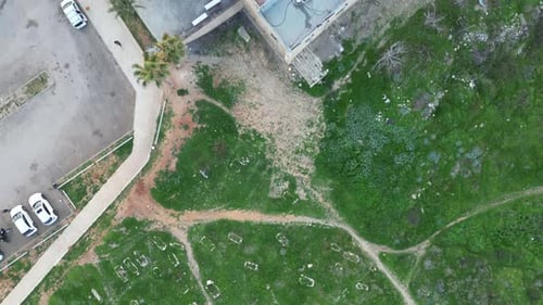 Aerial Panning Shot Sidna Ali Mosque Over Cliff Against Sky On Sunny Day