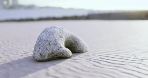 Unique Rock Formation on Sandy Beach During Sunset Near Coastal Area