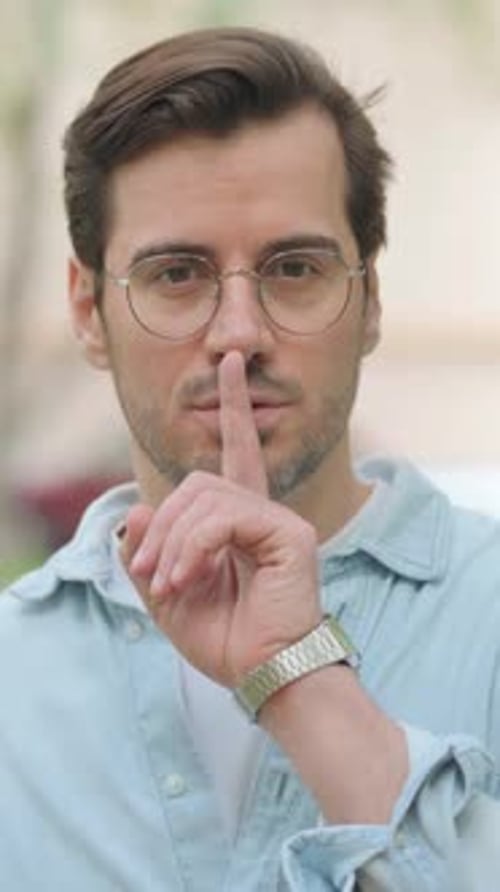 Silence Please Gesture by Casual Young Man Outdoor