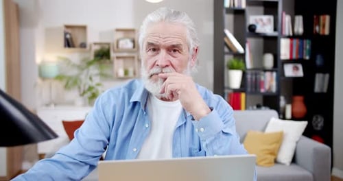 Senior Man Using Laptop Working at Home