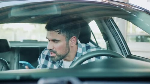 Man Talking on Phone While Sitting Inside Car