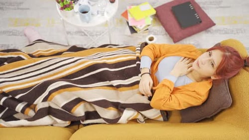 Young Adult Woman Sick on a Couch