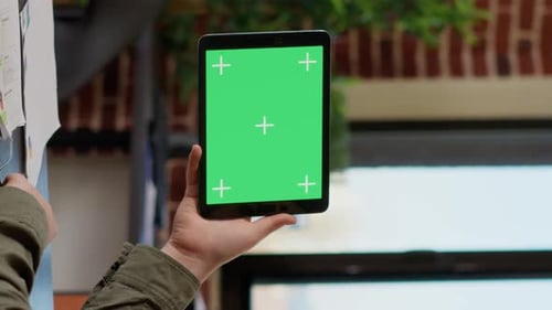 Vertical Video Office Worker Analyzing Horizontal Greenscreen on Tablet