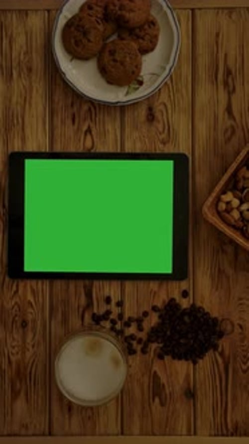Vertical of Tablet Near Biscuits and Cappuccino