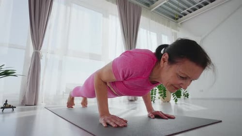 Woman Practicing Yoga Poses on Mat in Bright Room