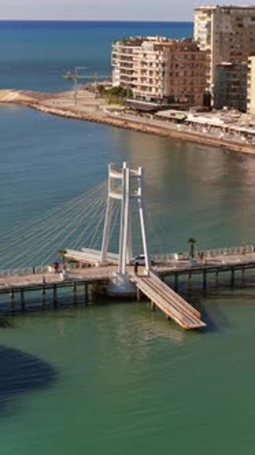 Aerial drone view of the iconic circular Rotonda building extending over the turquoise waters of the