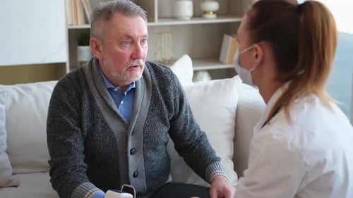 Female Doctor Examining Older Senior Man in Doctor Office or at Home Old Man Patient and Doctor Have