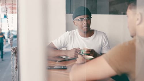 Friends, relax and men talking in coffee shop for bonding, discussion and chatting together
