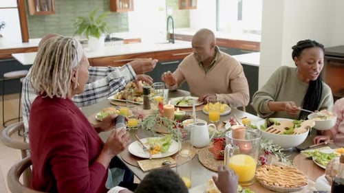 Family Meal Together Around Dining Table at Home