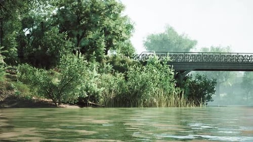 A Serene Riverside Landscape with a Bridge Surrounded By Lush Greenery