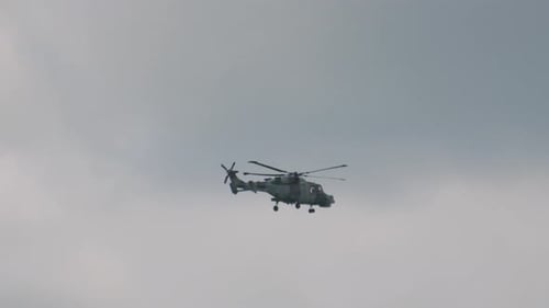 Military Helicopter Flies in the Cloudy Sky