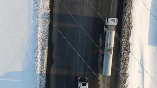 Trucks Transporting Goods on Snowy Winter Road