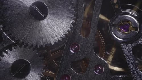 Light moving over shiny watch gears - Macro shot