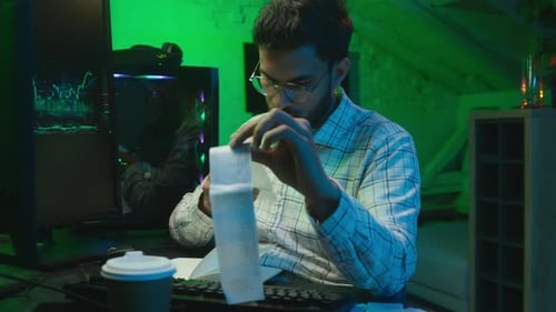 Young Adult Reviewing Finances at Modern Tech Office